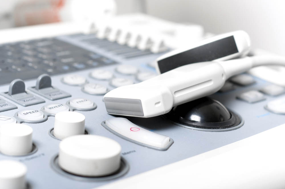 Several pieces of ultrasound equipment in a medical setting