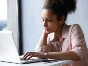 Young woman looking at laptop